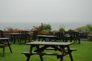 Picture of a view over wet benches into a grey and rainy distance