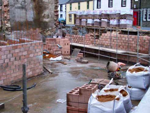 Picture of a building site, showing the basement, progress clearly visible