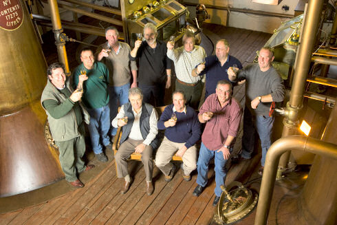 Picture of a group of people (farmers and whisky distillers) in a still house