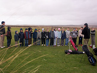 Picture of a group of children being taught by a golf teacher