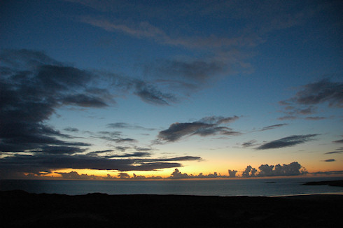 Picture of dramatic clouds at sunset over a wide bay on Islay
