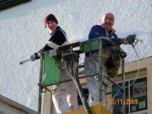 Picture of two painters in a cherry picker