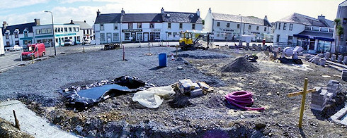 Panoramic picture of a view over a village square being refurbished