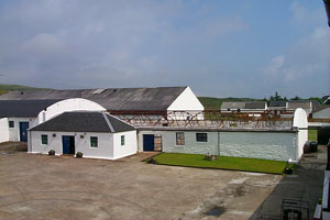 Picture of distillery buildings at Bruichladdich, one without a roof