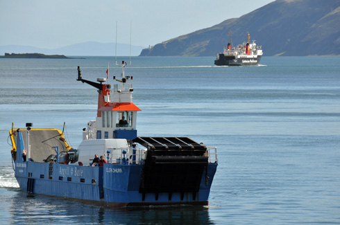 Picture of two ferries in a sound between two islands