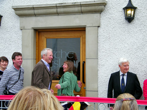 Picture of people standing in front of the newly opened the islay hotel, being asked to come in