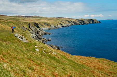 Picture of two walkers standing on low cliffs above a coast