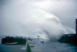Picture of a huge wave crashing over a pier