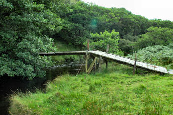 Picture of a rotting old bridge over a burn