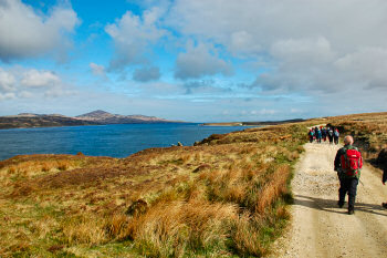 Picture of a group of walkers walking along a sound (Sound of Islay)