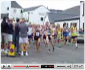 Screenshot of a YouTube video showing runners on a street