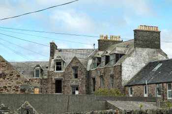 Picture of the back of a dilapidated building, the back of former Islay Hotel in Port Ellen