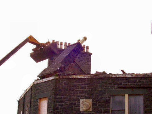 Picture of a digger pushing over a chimney