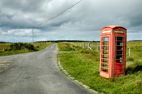 Picture of a single track road on Islay with a phonebox next to it