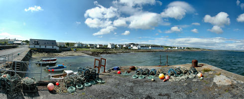 Picture of a panoramic view over a coastal village with a whisky distillery (Bruichladdich)
