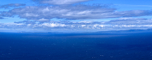 Picture of the coast of an island, seen across the sea