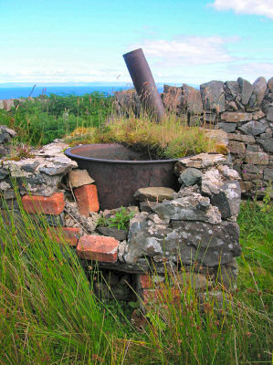 Picture of some kind of kettle in the ruins of a building