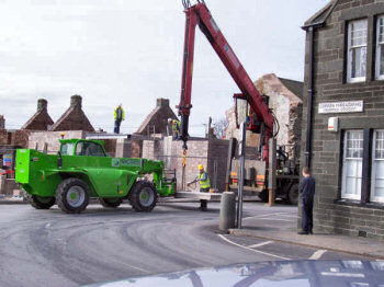 Picture of a forklift truck delivering concrete flooring to a crane