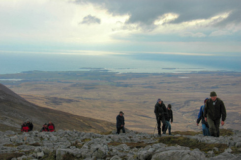 Picture of walkers arriving at the summit of a hill (Beinn Bheigier on Islay)
