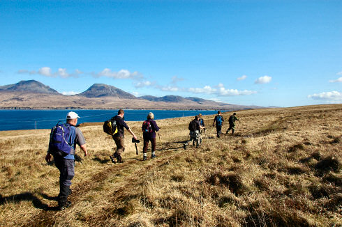 Picture of a group of walkers along the Sound of Islay with the Paps of Jura in the background