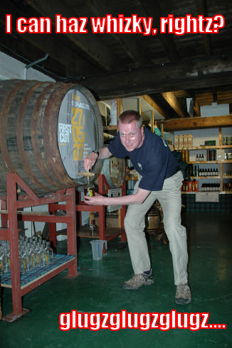 Picture of a man filling a bottle of whisky with a funny caption
