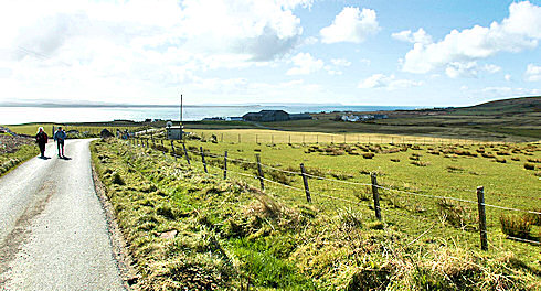 Picture of a view over a coastal village with distillery warehouse near a large sea loch