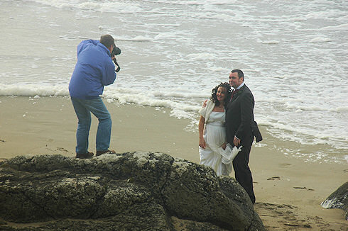 Picture of a photographer taking wedding pictures on a beach