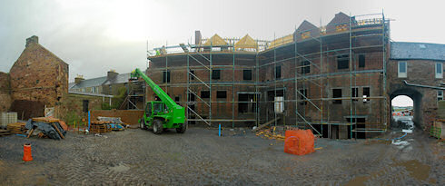Panoramic picture of the back of the under construction Islay Hotel in Port Ellen