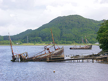 Picture of two fishing boat wrecks at the top of a sea loch