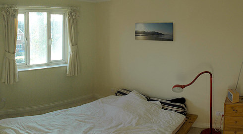 Picture of a bedroom with a panorama of an Islay sunset above the bed