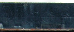 Picture of the letters MacB still visible on a repainted ship side