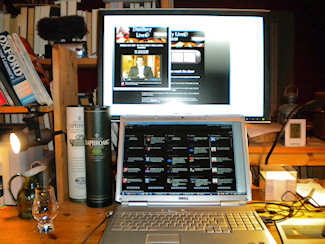 Picture of a large monitor and a laptop with the Laphroaig Live event on screen