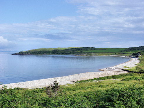 Picture of a bay with a pebble beach on a calm and sunny July evening