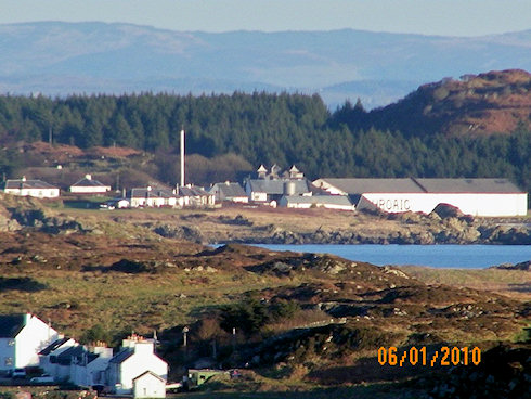 View of a distillery from a distance, a village in the foreground
