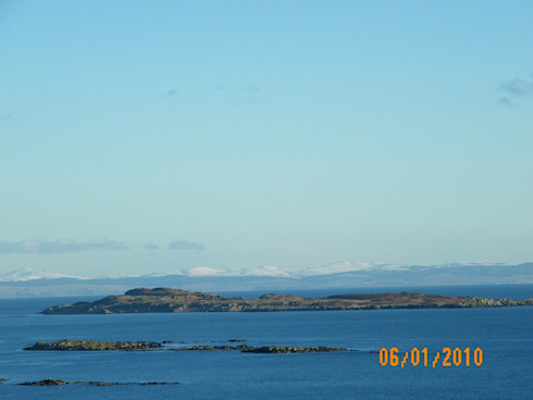 Picture of a view across the sea to snow topped hills