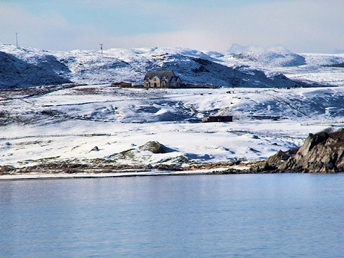 Picture of a snow covered hillside along a coast