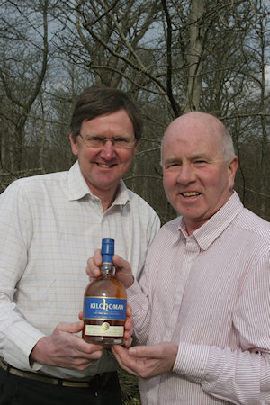 Picture of two men holding a Kilchoman whisky bottle