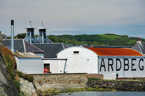 Picture of Ardbeg distillery seen from the rocky shore to the west of the distillery