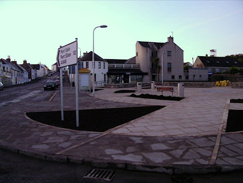 Picture of a village square next to the main street