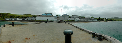 Panoramic picture of a coastal distillery, taken from the distillery pier