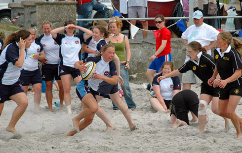 Picture of two ladies beach rugby teams in full action