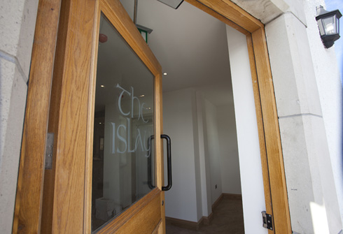 Picture of an open door, lettering in the window reads 'the islay'