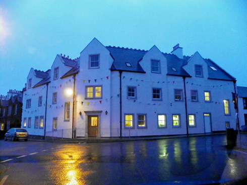 Picture of a hotel decorated with buntings on a rainy October evening