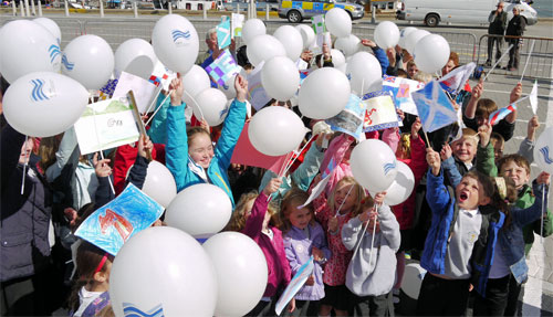 Picture of a group of children with balloons and flags