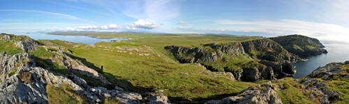 Panoramic picture of a view over steep cliffs and a wide landscape