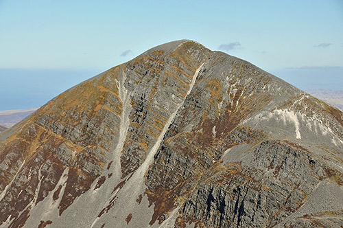 Picture of the scree covered side of a mountain with some steep cliffs thrown in