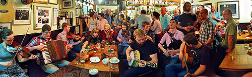 Panoramic picture of musicians in a busy pub