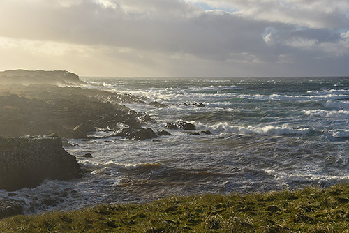 Picture of a bay with waves rolling in on a stormy day
